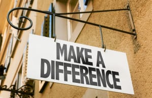 63388629 - make a difference signpost on building background