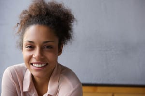 33727922 - close up portrait of a happy young black woman smiling