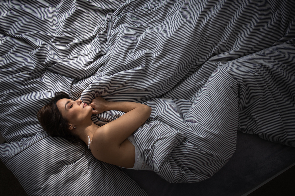 a woman in bed getting a good night's sleep