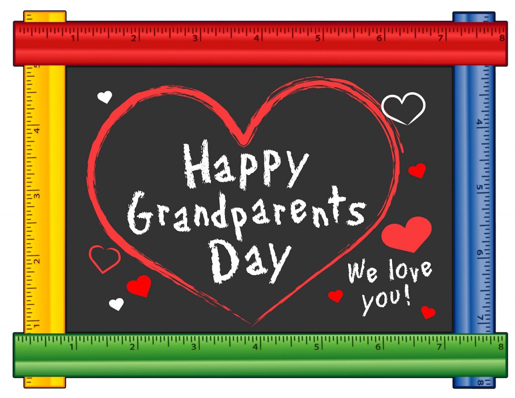 Grandparents Day, We love You! Hearts and kisses on national USA holiday first Sunday of September following Labor Day. Chalk text on ruler frame chalkboard for preschool, daycare, nursery school, kindergarten. Isolated on white background.