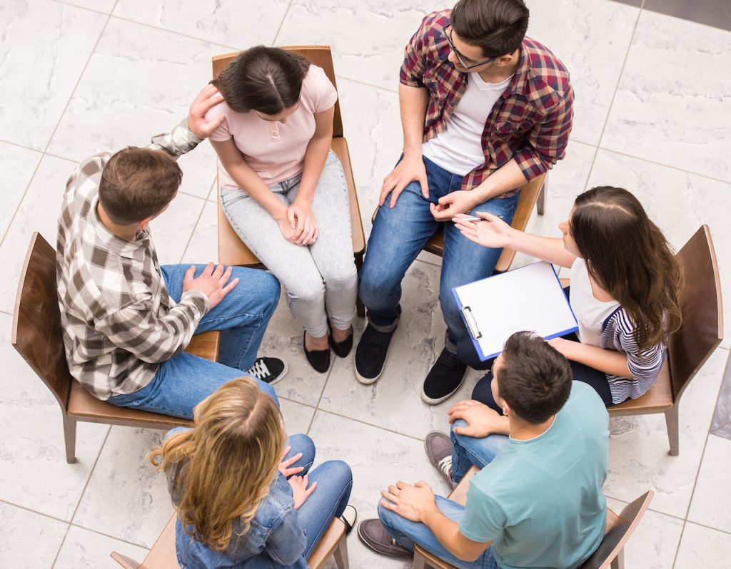 peer counseling therapy Group of people sitting close to each other and communicating.